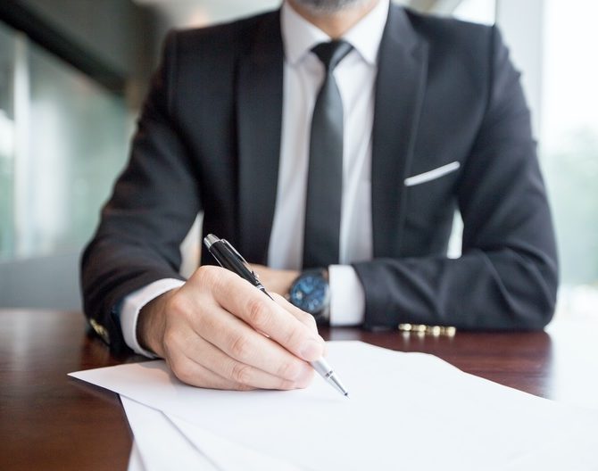 cropped view of business leader making notes