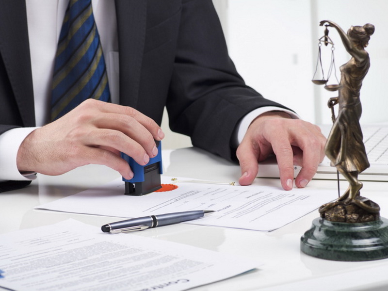 notary public signing document at his workplace