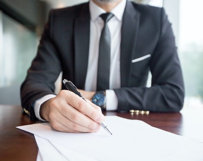 cropped view of business leader making notes