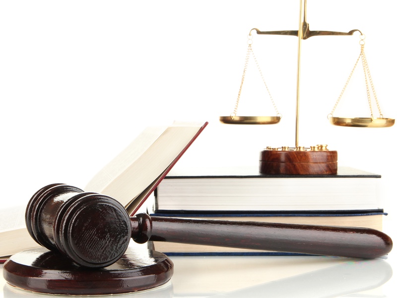 golden scales of justice, gavel and books isolated on white