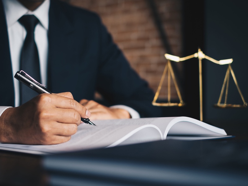 close up lawyer businessman working or reading lawbook in office workplace for consultant lawyer concept.