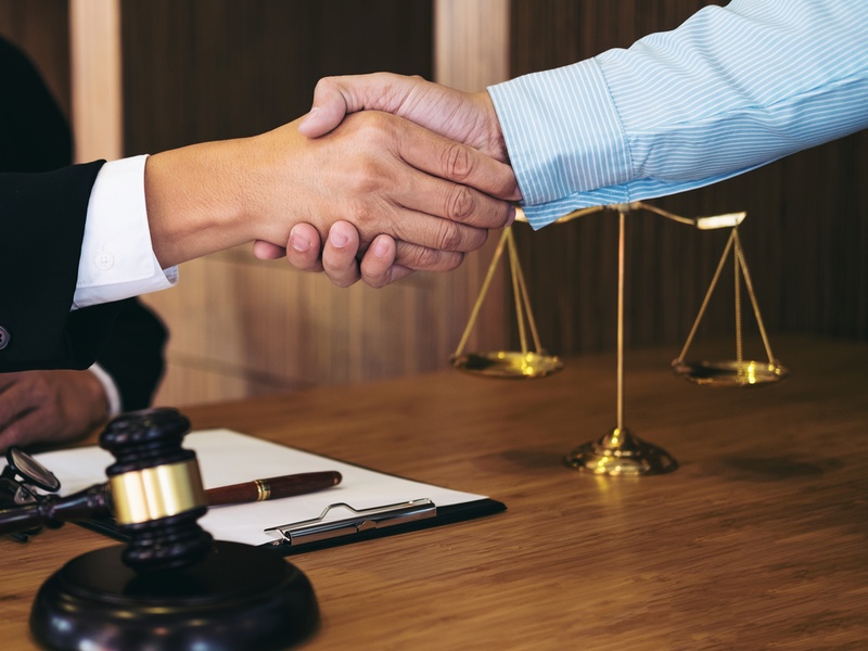 handshake after good cooperation, consultation between a male lawyer and businessman customer, tax and the company of real estate concept