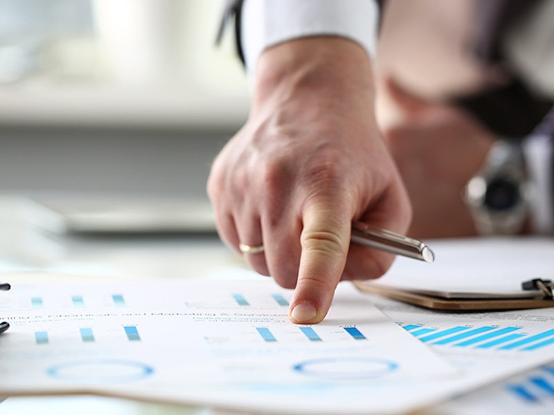 male arm point finger at important paper on table
