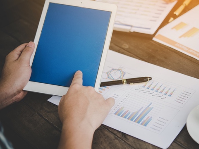 businessman using tablet to analysis with business chart marketing report, working at office.