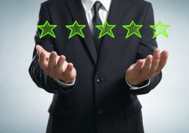 businessman holding five star rating.