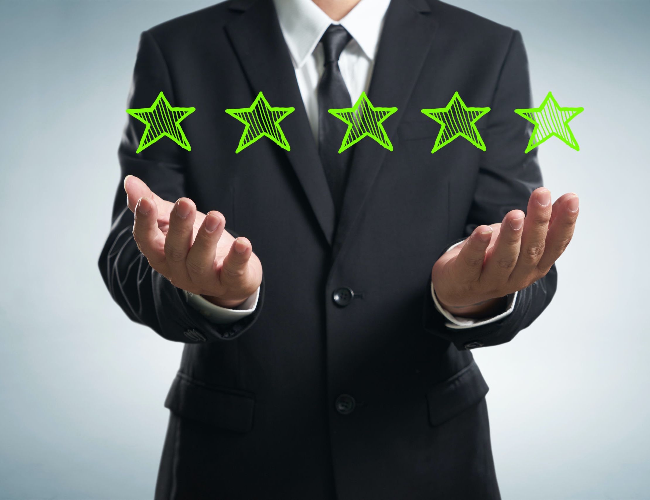 businessman holding five star rating.