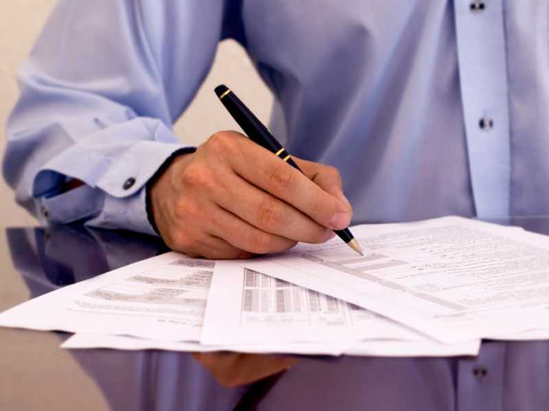businessman signing papers